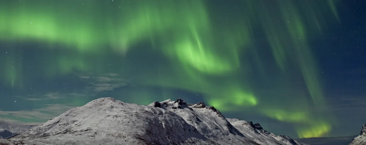 Northern lights over the Ersfjord in Tromso Bjorn Jorgensen Visit Norway com